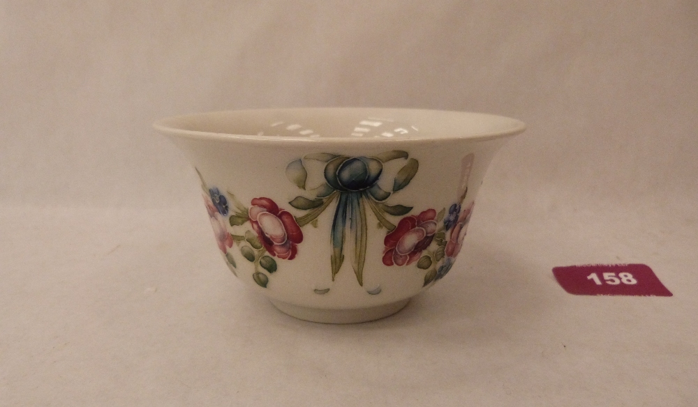 A William Moorcroft Macintyre bowl, decorated with a continuous garland of flowers and ribbon ties