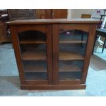 A pitch pine glazed bookcase. 44' wide (worm)