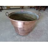 A copper log bin. 29' diam over handles