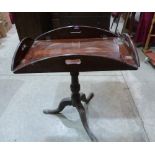 A mahogany butler's tray on associated tripod support