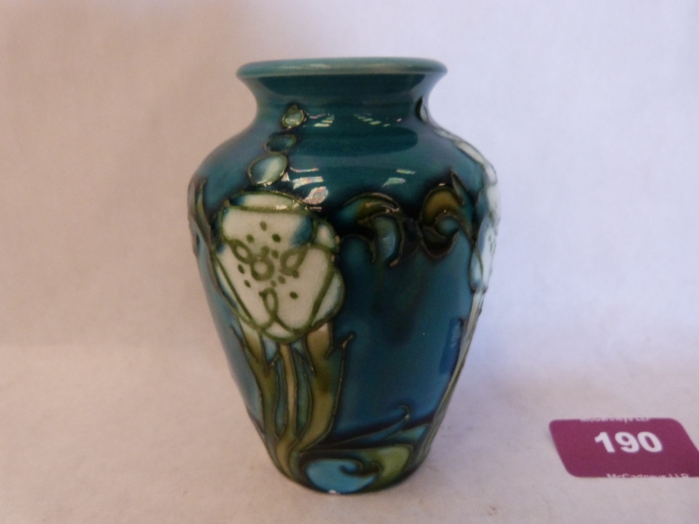 A Minton Secessionist vase, number 7, tube-line decorated with stylised foliage on a blue ground.