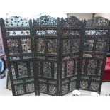 An Indian carved and pierced hardwood four-fold screen. 75' high x 85' wide