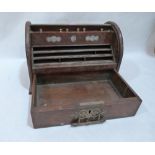 An oak stationary box enclosed by a tambour shutter over a base drawer. 12' wide