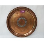 A Hugh Wallace planished copper and silvered dish, the centre with a ring of fruiting foliage.