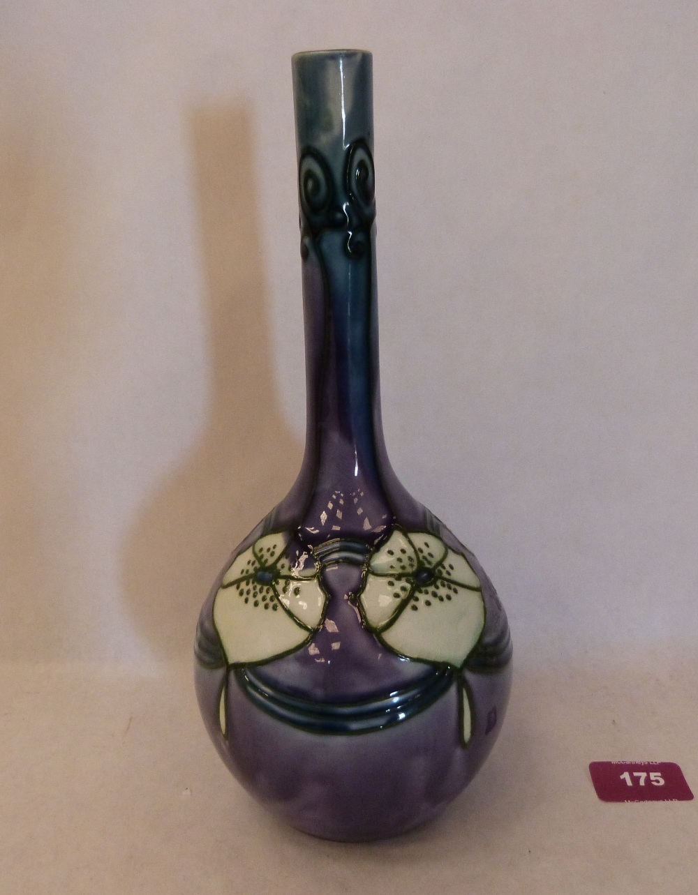 A Minton Secessionist vase, number 29, tube-line decorated with white on a purple ground. Factory