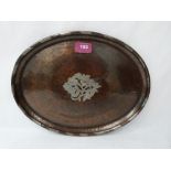 A Hugh Walker planished copper and silvered oval dish, the centre with fruiting foliage. Impressed