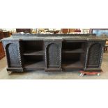 A Victorian 'gothic' oak carved open bookcase. 108' wide