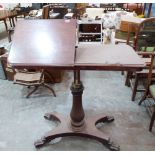 An early Victorian mahogany reading table, the rising top with two ratchet bookrests, on baluster