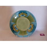 A Minton majolica secessionist design plate, tube-line decorated with stylised foliage in shades