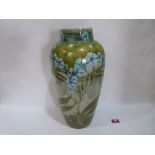 A Mintons secessionist ovoid vase, decorated with tube-lined blue flowers and foliage on a light