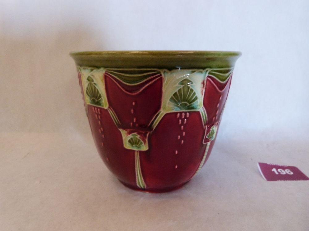 A secessionist design jardiniere, tube-line decorated with stylised foliate motifs on a blood red