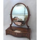 A George III mahogany dressing table mirror, the oval plate over a crossbanded and line inlaid