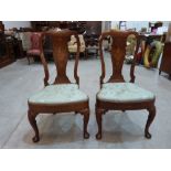 A fine pair of Queen Anne walnut side chairs, inlaid with classical urns, ribbon ties, swags and