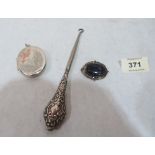 A silver pendant locket, 2' high; a Victorian silver brooch and a silver handled buttonhook