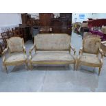 A late 19th century French carved giltwood canape with a pair of matching armchairs