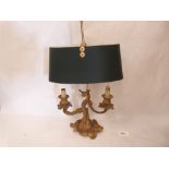 A rococo revival ormolu two light table lamp (Formerly a three light candelabrum)