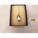 A 14ct pendant and chain set with a light blue stone. Chain 9ct. 4g gross