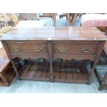 An oak dresser base with a pair of frieze drawers on baluster turned legs united by a pot board. 54'