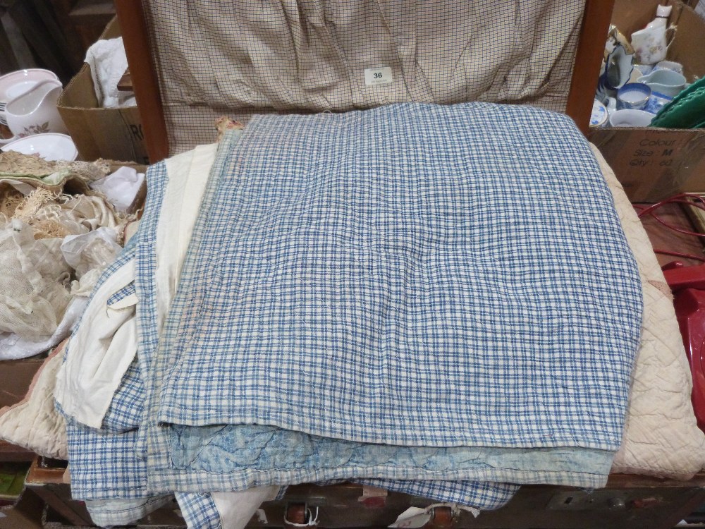 Three vintage quilts and other textiles in a vintage case