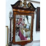 A George II style walnut and parcel gilt pier glass in the manner of William Kent. Of recent