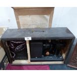 A vintage movie projector in case. The Alpha Filmstrip Lantern