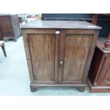 A 19th century mahogany side cabinet enclosed by a pair of panel doors on bracket feet. 36' wide