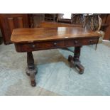 A William IV rosewood library table with a pair of frieze drawers, raised on baluster carved end