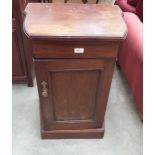 A Victorian walnut pot cupboard enclosed by a panel door. 21' wide