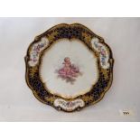 A 19th century Sevres plate, the centre painted with a putto on a cloud, the blue ground and