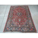A red ground eastern rug. 73' x 50'
