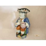 A 19th century Staffordshire Toby jug, he seated holding a glass and a Sunderland lustre jug. 10'