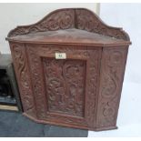 An oak carved hanging corner cabinet. 19' high