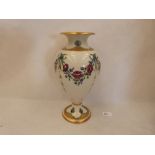 A William Moorcroft for Macintyre inverted baluster vase, decorated with garlanded flowers and