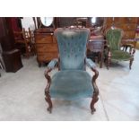 A Victorian mahogany parlour armchair with deep buttoned shaped back and shepherd's crook open arms,