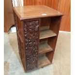 An early 20th century revolving bookcase carved with berry fruits. 30' high