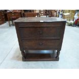 A mid 17th century small joined oak chest of two drawers on baluster turned supports united by a