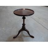A 19th century mahogany wine table on wrythen turned column and leaf moulded cabriole support. 12'