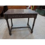 A 17th century joined oak side table with scroll carved frieze, on bobbin turned legs and