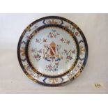 A 19th century porcelain armorial plate, the coat of arms surrounded by scattered flowers,