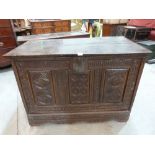 A mid-17th century joined oak carved three panel chest raised on stiles, the interior formerly