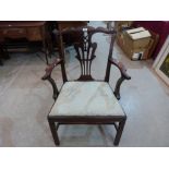 A George III mahogany elbow chair of Chippendale style, on moulded chamfered square legs