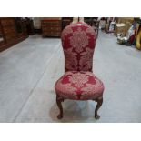 A Queen Anne walnut and upholstered side chair on foliate inlaid and scroll carved cabriole legs