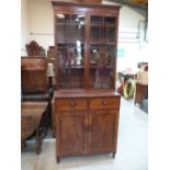 A Regency mahogany bookcase, the upper part enclosed by a pair of astragal glazed doors, each with