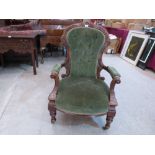 A Victorian walnut parlour armchair with deep buttoned shaped back and scrolled open arms