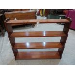 A mahogany wall rack with four graduated shelves. 39' wide