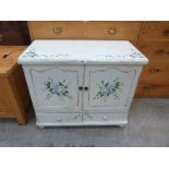 A cabinet painted with roses. 31' wide
