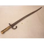 A 19th century French sword bayonet, the blade inscribed 'Mre. d'armes des etats 1873'. The blade