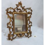 A gilt brass Florentine style strut mirror. 11' high