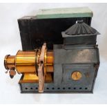 A Victorian magic lantern with tin case, the lens tube engraved 'The Praestantia, Riley Bros. Ltd,