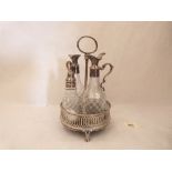 A George III silver cruet stand, with a pair of glass oil bottles and a salt bottle. One bottle